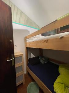 a bedroom with two bunk beds with a ladder at Sunclass Tignale Bungalow Gardasee in Tignale