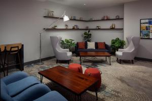 a living room with chairs and a couch and a table at The Bethesdan Hotel, Tapestry Collection by Hilton in Bethesda +78 photos