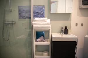 a bathroom with a shower and a sink and towels at Quiet Nature Studio in Lahemaa, Garden, Terrace and pet friendly in Kolga +15 photos