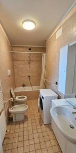 a bathroom with two toilets and a tub and a sink at Appartamenti Vista Lago - Costermano sul Garda - Be Happy! in Costermano sul garda +11 photos