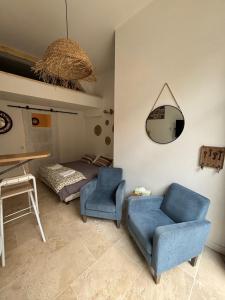a bedroom with a bed and a chair and a mirror at Les Capucins de Provins Studio in Provins +3 photos