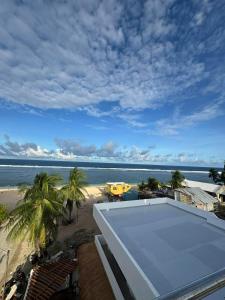 a view of the beach from the roof of a building at Bulan Guesthouse in San Isidro