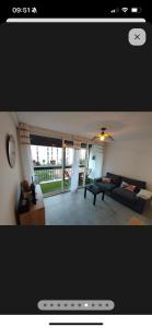 a living room with a couch and a table at Blue lagon-350m plage-clim-parking in Saint-Cyprien-Plage