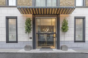 a building with two potted plants in front of it at The Morrison Dublin, Curio Collection by Hilton in Dublin