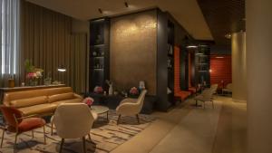 a lobby with a couch and chairs and tables at The Morrison Dublin, Curio Collection by Hilton in Dublin
