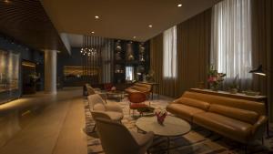 a living room with a couch and chairs and tables at The Morrison Dublin, Curio Collection by Hilton in Dublin +98 photos