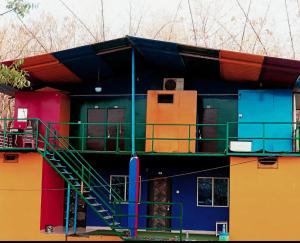a colorful building with a staircase on the side of it at Royal Resort in Indore