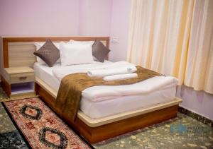 a bedroom with a bed with two towels on it at HN Guest House in Shillong