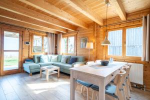 a living room with a couch and a table at Strandhus Mira in Dahme