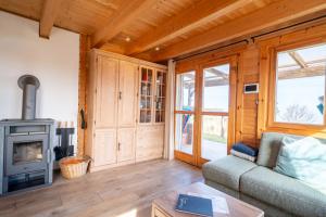 a living room with a couch and a stove at Strandhus Mira in Dahme