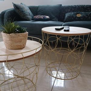a living room with two tables and a couch at Duplex Green Village in Grande Gaube