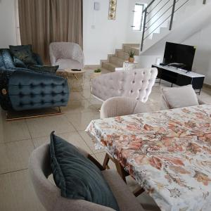 a living room with a table and chairs and a piano at Duplex Green Village in Grande Gaube