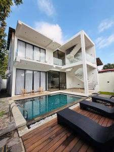 a house with a swimming pool in front of it at La Vizta Weligama in Weligama