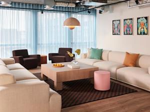 a living room with couches and a coffee table at Numa Rotterdam Coolsingel in Rotterdam