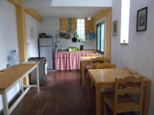 uma cozinha com mesas de madeira e uma cozinha com um balcão em Misurino em Paul