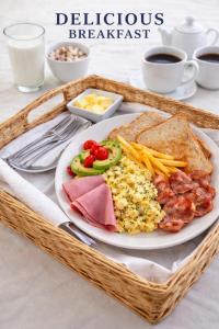 a basket of breakfast with a plate of food at PrimeStay One 2 Bedroom Apartment in Johannesburg