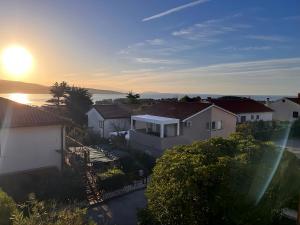 an aerial view of a house with the sun setting at Meldaria Residence in Krk