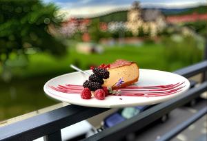 a piece of cake on a plate on a table at Glory Apart Polyana in Polyana