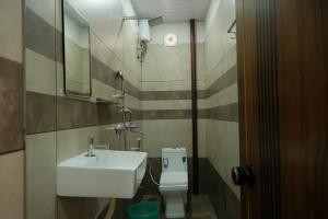 a bathroom with a sink and a toilet at The Varghese Beth in Munroe Island