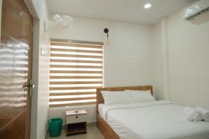 a bedroom with two beds next to a window at The Varghese Beth in Munroe Island