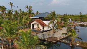 an aerial view of a house next to a body of water at The Varghese Beth in Munroe Island