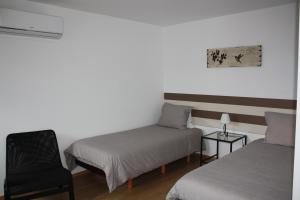 Ένα ή περισσότερα κρεβάτια σε δωμάτιο στο Casa Nª Sra. do Carmo - Villas