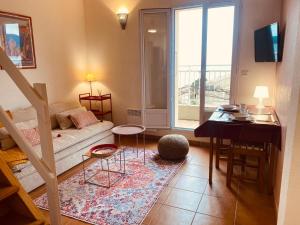 a small living room with a couch and a table at Le Panoramic in Saint-Florent