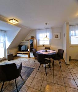 a living room with a table and chairs at _Neue Liebe_ Wohnung 3 in Groß Kirr