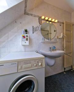 a bathroom with a washing machine and a sink at _Neue Liebe_ Wohnung 3 in Groß Kirr +19 photos