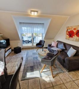a living room with a couch and chairs at Neue Liebe Wohng_4 in Groß Kirr