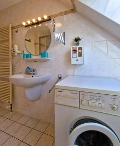 a bathroom with a washing machine and a sink at Neue Liebe Wohng_4 in Groß Kirr +18 photos