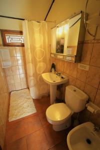 a bathroom with a white toilet and a sink at Casa Tajinastes del Teide in Las Cañadas del Teide
