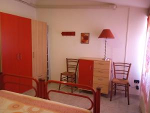 a bedroom with a bed and a dresser and chairs at In Sardegna da Anna Rita in Scano Montiferro +5 photos