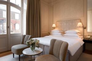 a hotel room with a large bed and two chairs at Hotel Diplomat Stockholm in Stockholm +50 photos