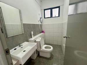 a bathroom with a toilet and a sink and a mirror at PeaceStay in Sandakan +4 photos