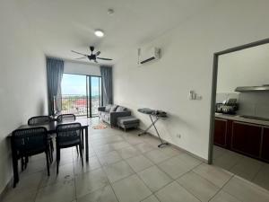 a living room with a table and chairs and a couch at PeaceStay in Sandakan