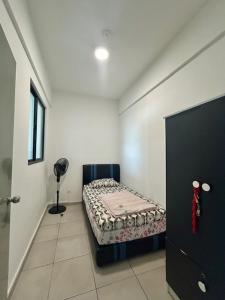 a room with a bed in the corner of a room at PeaceStay in Sandakan