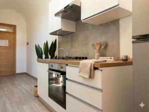 a kitchen with a sink and a stove top oven at Central Suite - Premium Villas in Giulianova