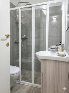a bathroom with a shower and a sink and a toilet at Central Suite - Premium Villas in Giulianova