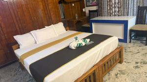 a large bed in a room with at Thanal Home Stays in Kollam