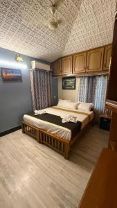 a bedroom with a large bed in a room at Thanal Home Stays in Kollam