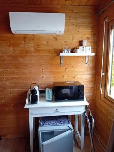 a small kitchen with a stove and a microwave at Chalet d'Art in Saint-Georges