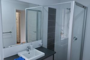 a bathroom with a sink and a glass shower at Sweet Home Property Forrestfield in Perth +24 photos