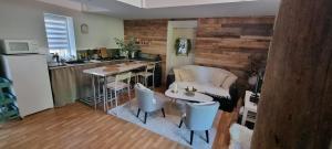 a kitchen with a couch and a table in a room at Maison Oscar et Petrus in Beaumont-du-Gâtinais