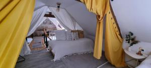 a bedroom with a bed in a tent at Maison Oscar et Petrus in Beaumont-du-Gâtinais