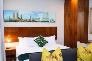 a hotel room with two beds and a couch at Umhlanga Apart Hotel in Durban +27 photos