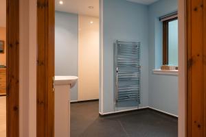 a bathroom with blue walls and a sink and a mirror at Lakeside Lodge, Views, Hot Tub & Fully Accessible in Elgin +43 photos