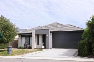 a house with a garage in front of it at Sweet Home Property Forrestfield in Perth