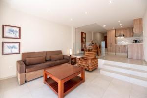 a living room with a couch and a table at Apartamentos Vista Sur in Playa de las Americas