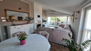 a living room with a couch and a table at House Anastazia Pool & Panoramic Sea View in Lovran